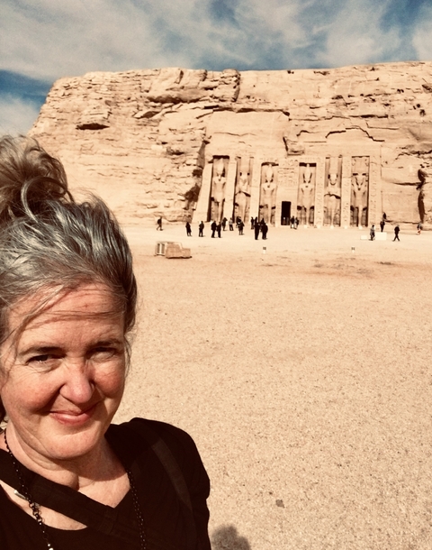       Person with a historical monument in the background.
  