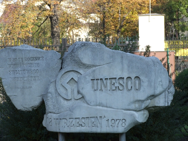 UNESCO World Heritage site marker with trees in the background.