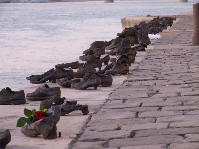 Shoes on the Danube Bank with a rose, part of a memorial.