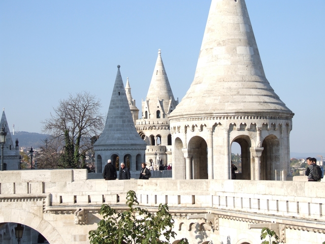 People walking on Fisherman's Bastion with iconic architecture.