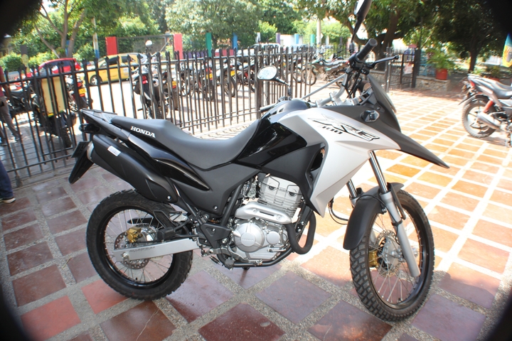       Close-up of a Honda motorcycle in a parking area.
  