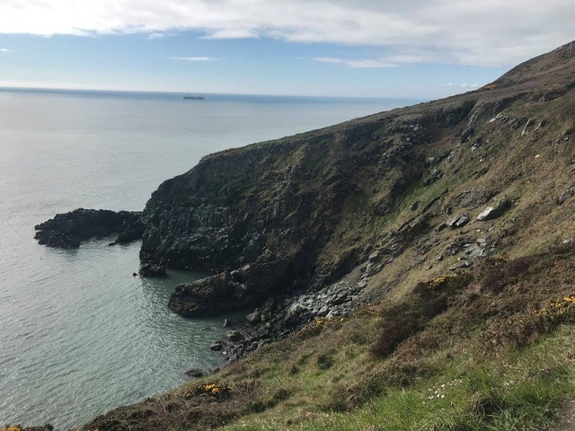 Scenic coastal landscape with cliffs and sea.