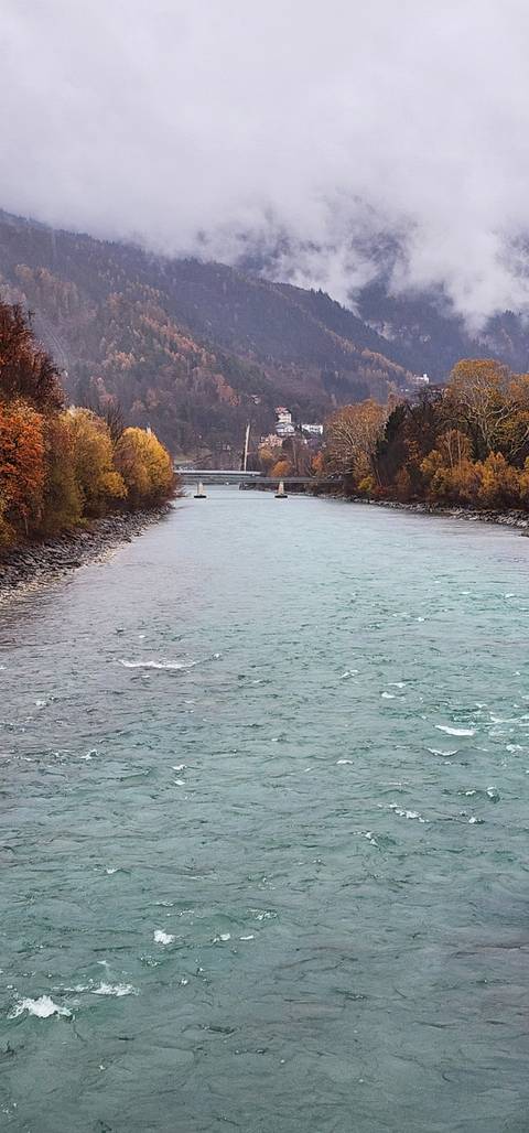       River with mountains in the background during a cloudy day.
  