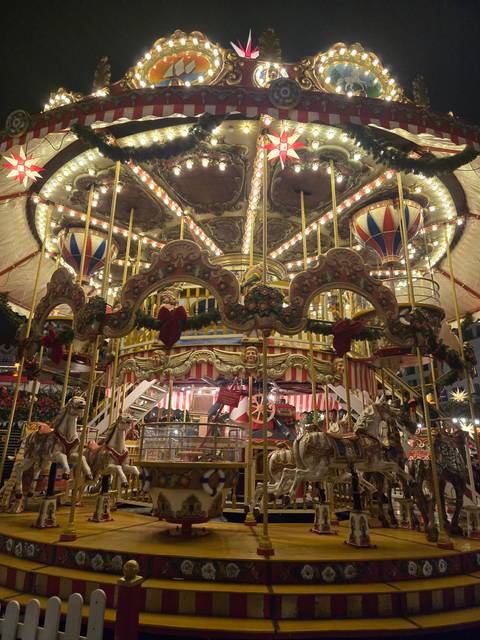Upside-down photo of a carousel at night.