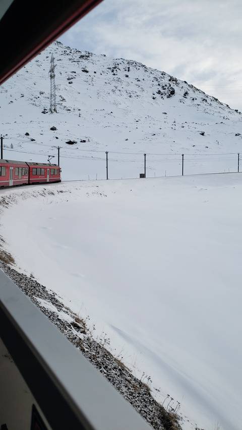 Train on a snowy mountainside during winter.