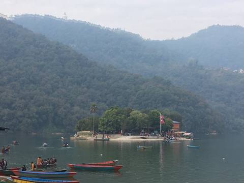 Lake with boats and surrounding forests.