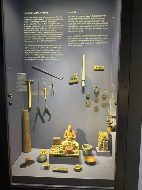 Exhibit of historical artifacts and tools on a display with textual description.