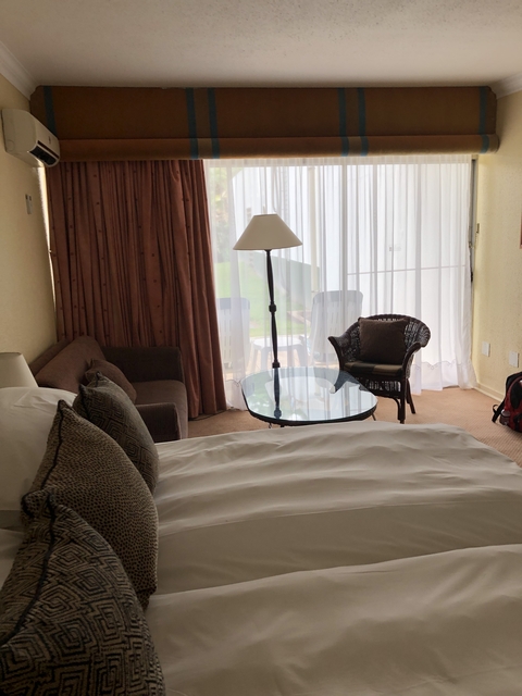 Cozy hotel room with a bed and natural light.