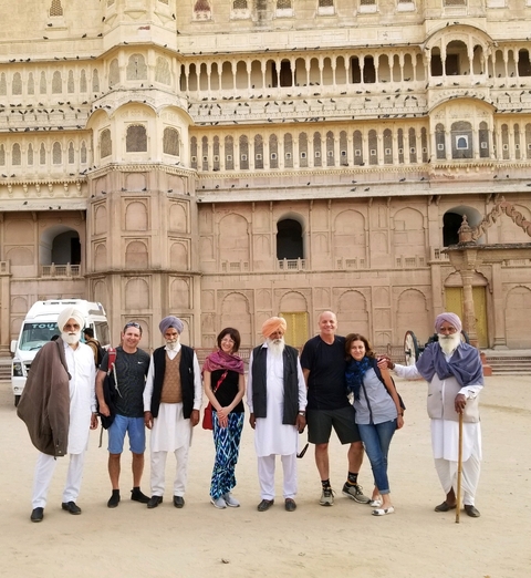 Group of people standing in front of an ornate building.