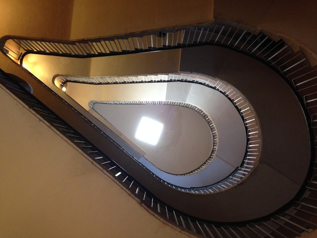 A spiraling staircase viewed from above, creating a geometric pattern.