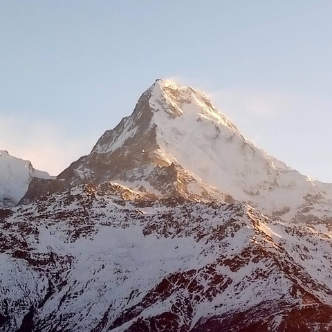 Close-up of a snow-capped peak under sunlight.