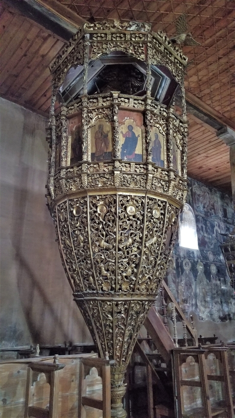       Close-up of an intricately carved lectern in an old church.
  