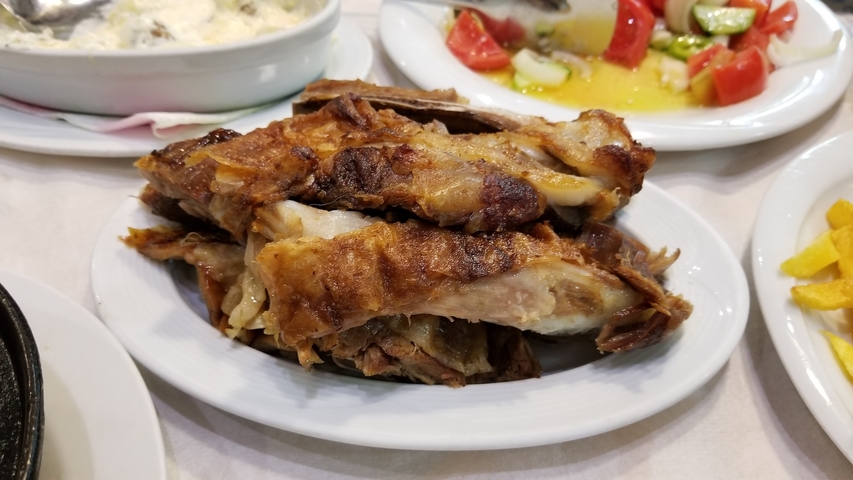       A plate of grilled meat and salad.
  