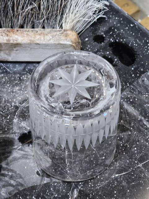       Close-up of a carved crystal glass.
  