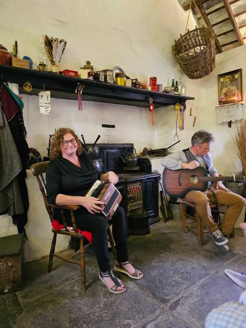       Musicians performing in a cozy indoor setting.
  