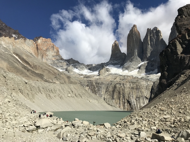 Towering peaks surrounding a glacial lake.