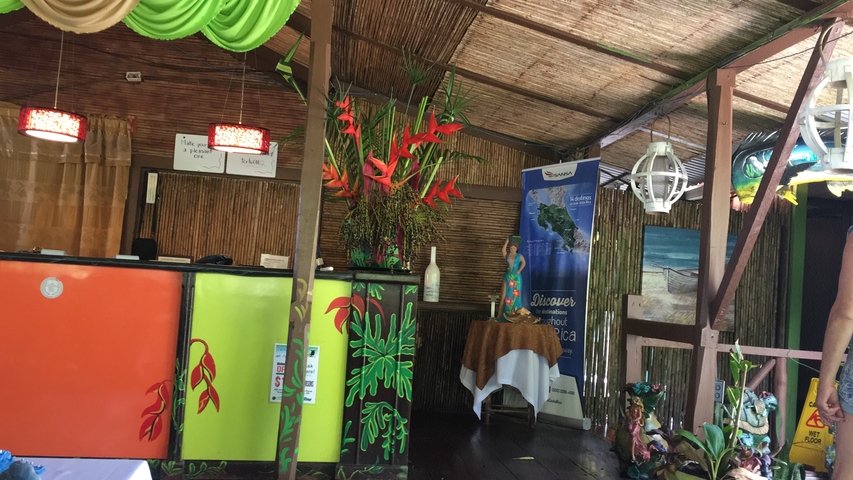       Reception area of a tourist venue with tropical decorations.
  