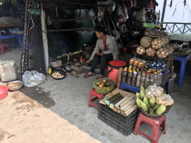 Market stall with a woman cooking and selling goods