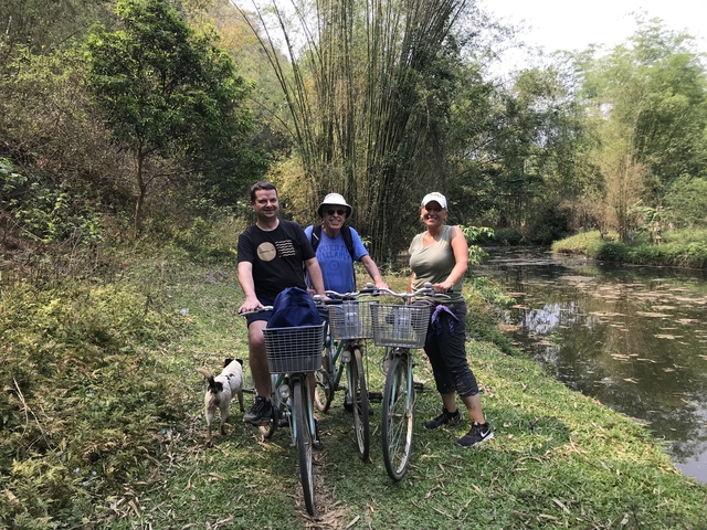       Group of people with bicycles near a water body
  