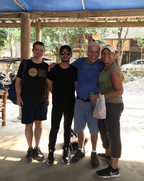       Group of people posing for a photograph outside
  