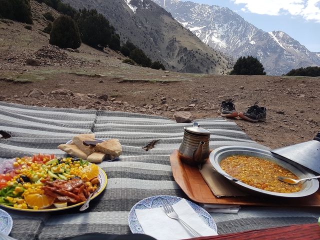 Picnic setup with mountain view and traditional meal