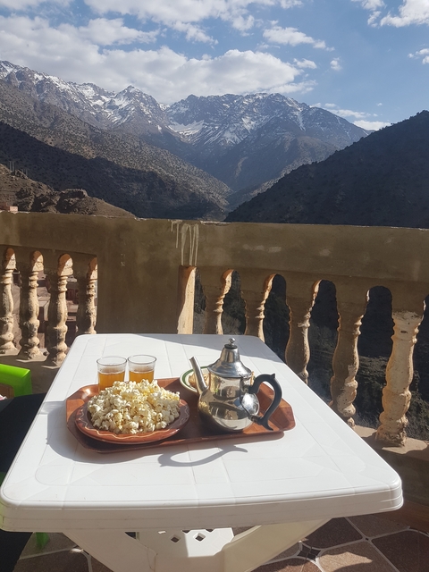 Mountain view from a terrace with tea set and snacks