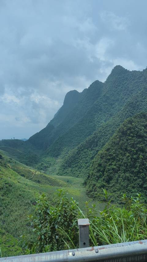       Mountainous landscape with a lush green valley.
  
