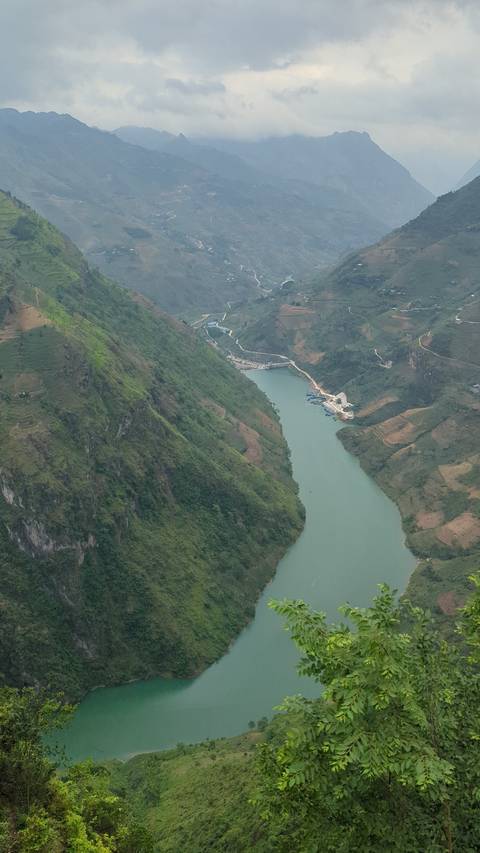 River winding through a green mountainous area.