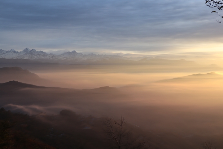       Golden sunrise illuminating mountain valleys.
  