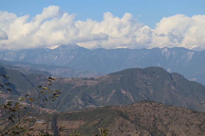       Himalayan mountains with clear skies and rolling hills.
  