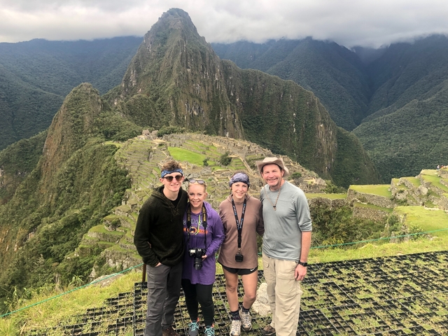 Family portrait at Machu Picchu with the ruins in the background.