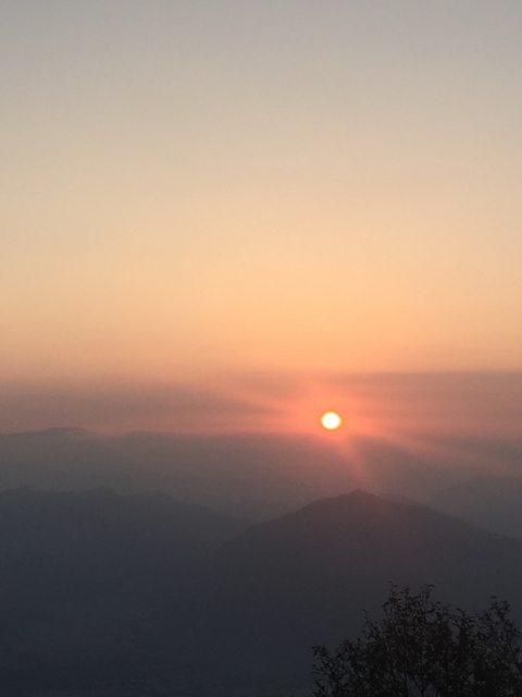       A sunset view with the sun setting over the horizon.
  