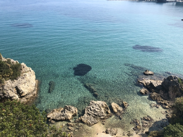      Rocky coast with clear blue waters.
  