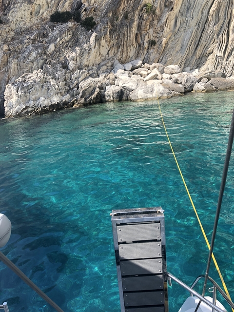       Clear turquoise water near rocky shore.
  