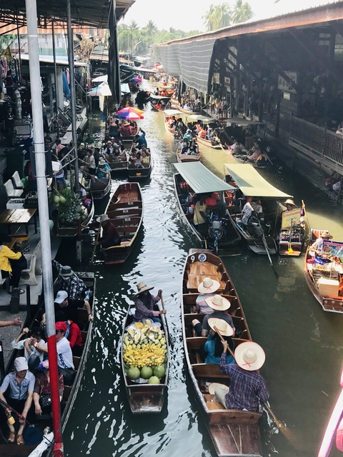 Busy river market with people on boats.