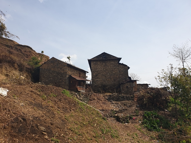       Rural stone house on a hillside.
  