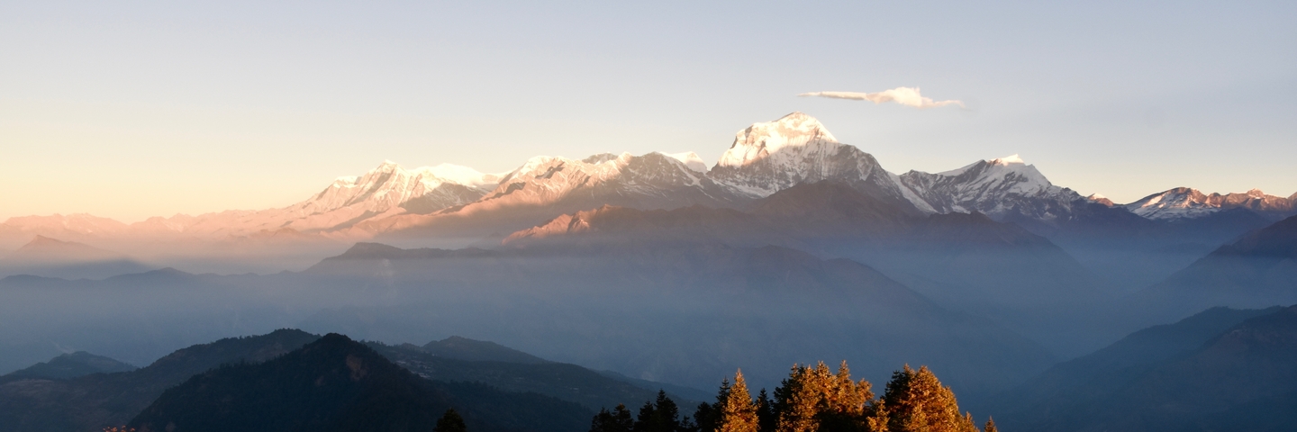 Sunrise illuminating snow-capped mountains.