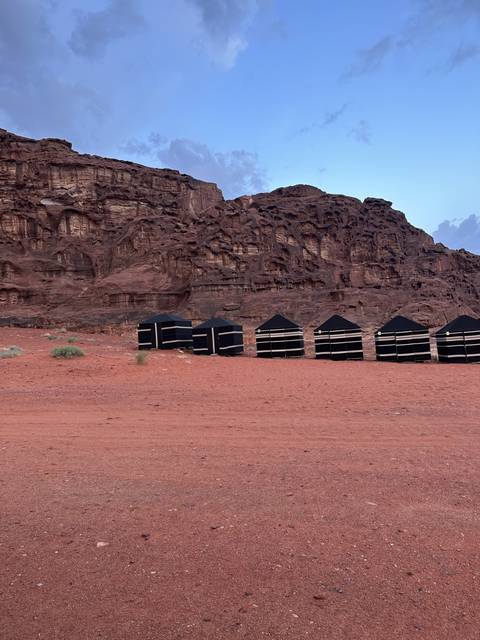 Desert tents with rocky hills.