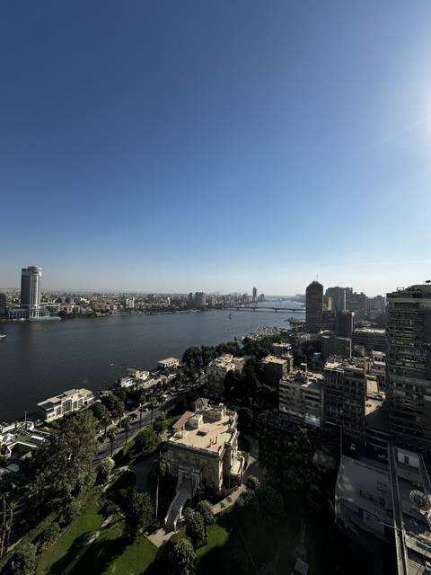       A cityscape with a river running through it.
  