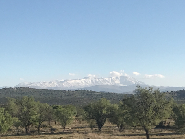 Snow-capped mountain range under a clear blue sky.