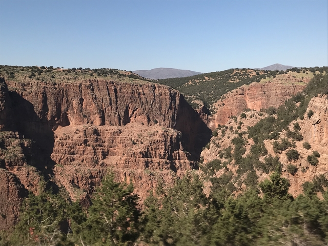       Expansive view of a rugged canyon with red rock formations.
  