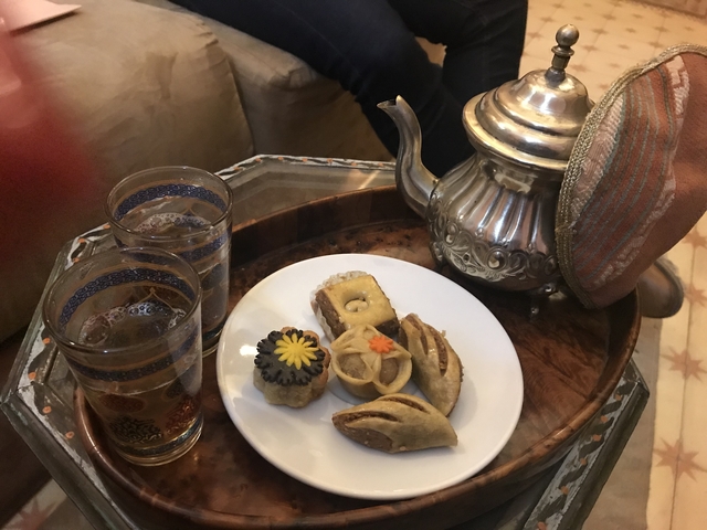 Moroccan tea setup with traditional sweets.