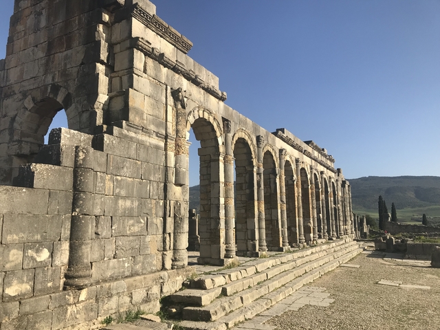 Ancient Roman ruins featuring columns and arches.