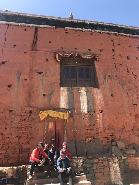 Brick wall with traditional decorations and small windows.