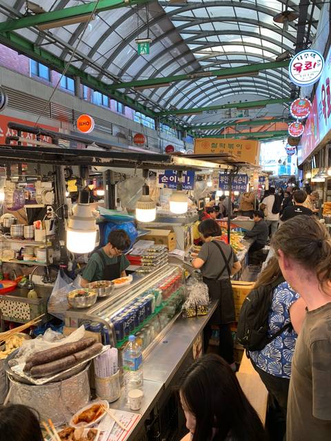 Cultural market scene with vendors and assorted goods.
