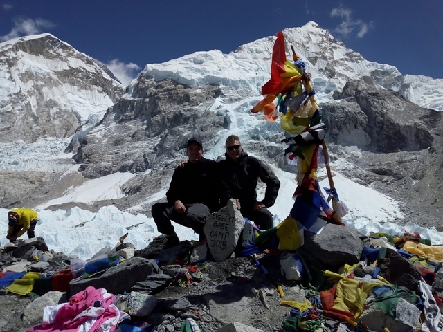 Two people posing at Everest Base Camp.