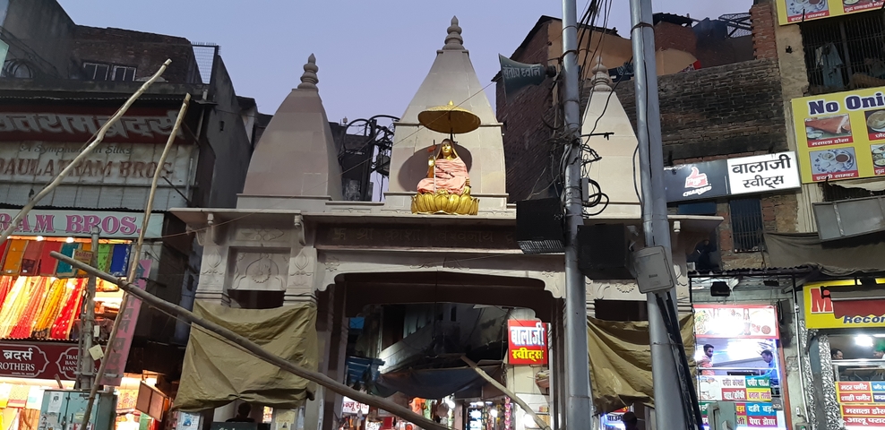 Architectural detail of a gate in a busy market area.