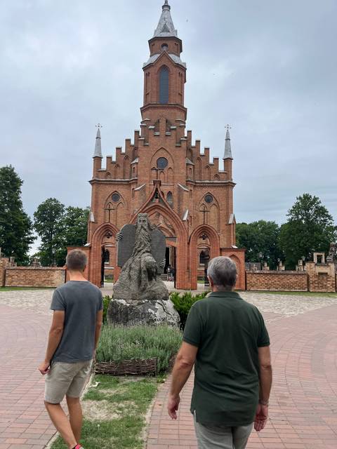 Upside-down view of a church and tourists in foreground.