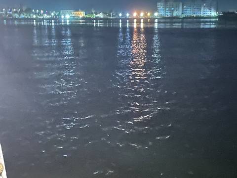 Abstract reflection in a dark body of water.