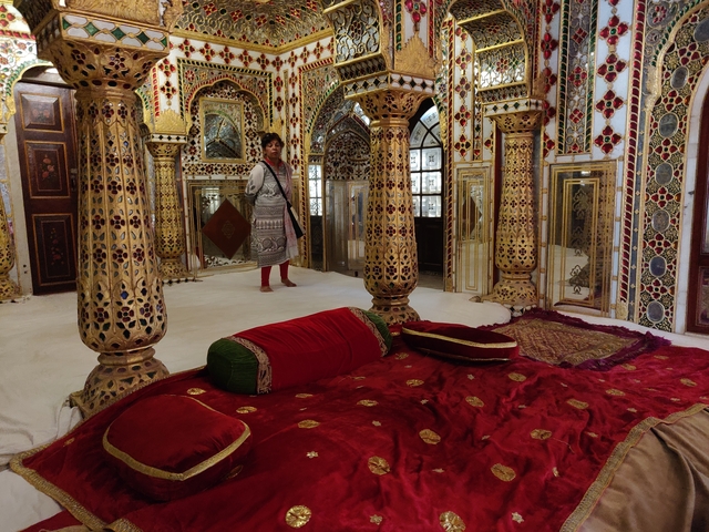 Intricate and ornate room with a person standing inside.